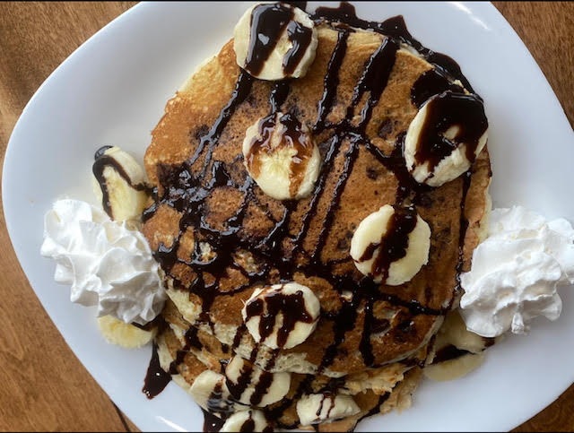 "Chocolate Monkey" pancakes: Pancakes with bananas, drizzled with chocolate and topped with whipped cream